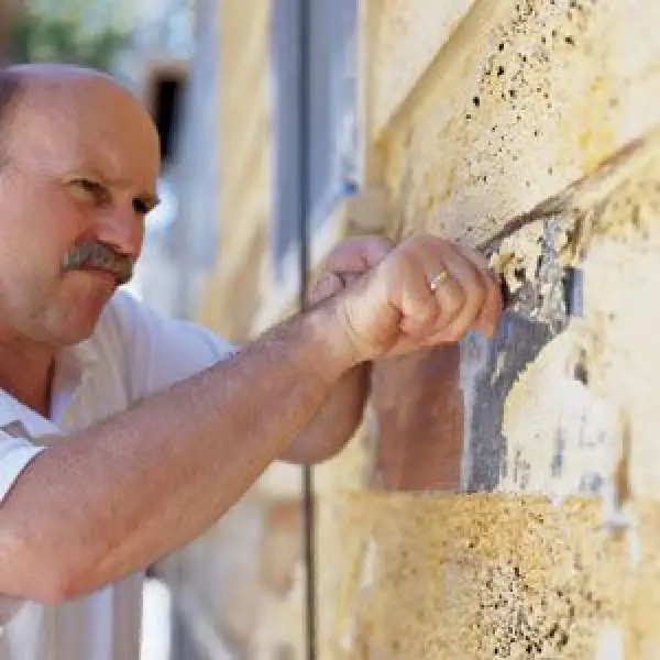 a man removing lead paint